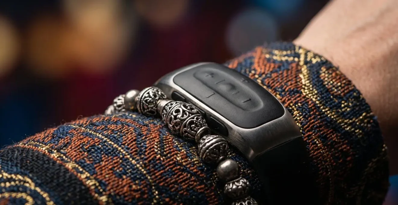 Extreme close-up of a discrete wearable safety device on a performer's wrist