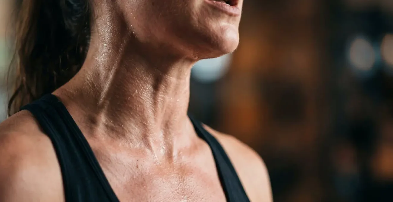 Close-up of vocalist's throat and chest during high-intensity cardiovascular training with vocal exercise